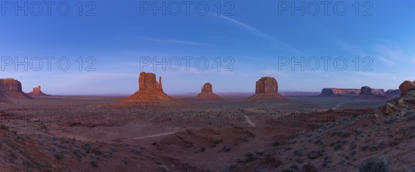 A panorama picture of the Monument Valley landscape in the early evening or night, with the West