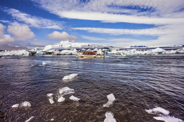 The trash-ice on Jokulsarlon, Iceland. Striped clouds beautifully reflected in the smooth water of
