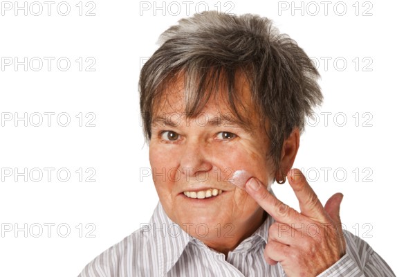 Senior woman with cream pot cropped on white background