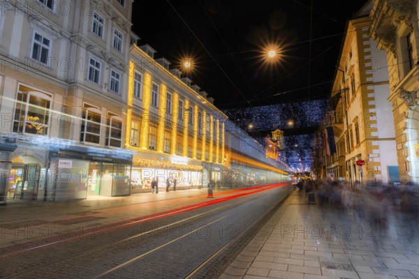 Advent atmosphere, Christmas illuminated Herrengasse, light tracks of a tram, Graz, Styria,