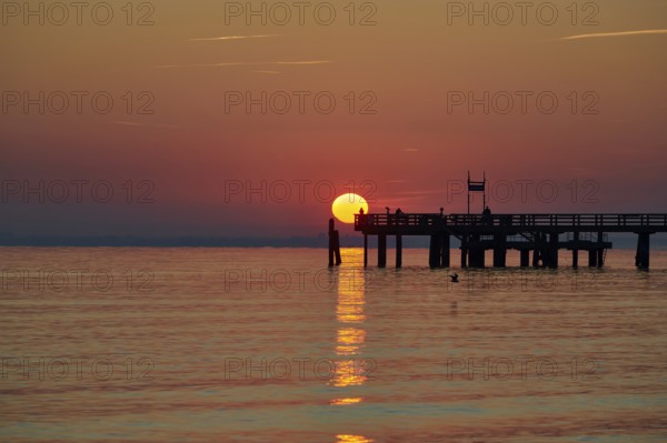 Red sunrise over the sea at the pier of the Baltic Sea resort, Boltenhagen, Mecklenburg-Vorpommern,