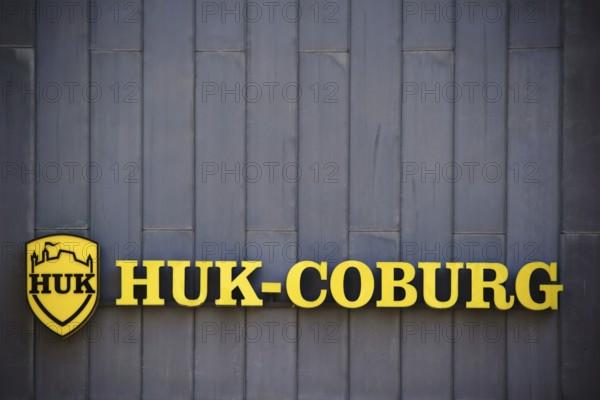 Mainz, Germany - July 06, 2017: The yellow company sign and logo of the insurance company HUK
