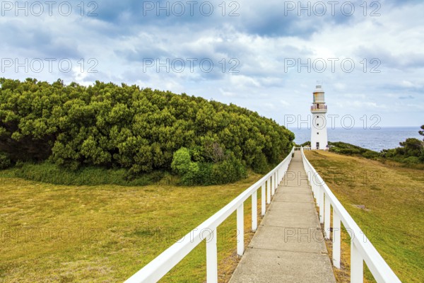 Magnificent lighthouse on the ocean shore. The Great Ocean Road runs along the Pacific coast of