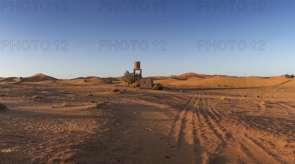View of offroad vehicle tracks leading into the sand dunes of Erg Chebbi in the Sahara Desert of