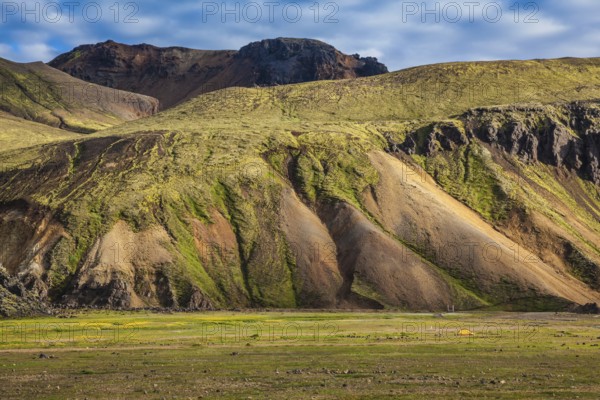 Multicolored rhyolite mountains surround the valley. Summer morning in the National Park