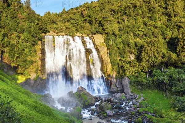 North Island. The largest and widest waterfall in Marocopa. The setting sun illuminates the stormy