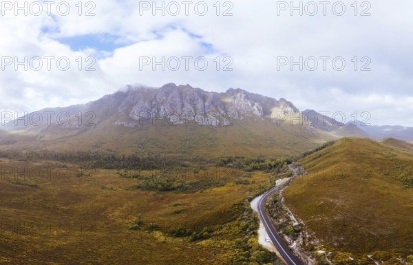 An aerial view of Gordon River Rd at the Sentinel range of mountains near Bitumen Bones Sculpture