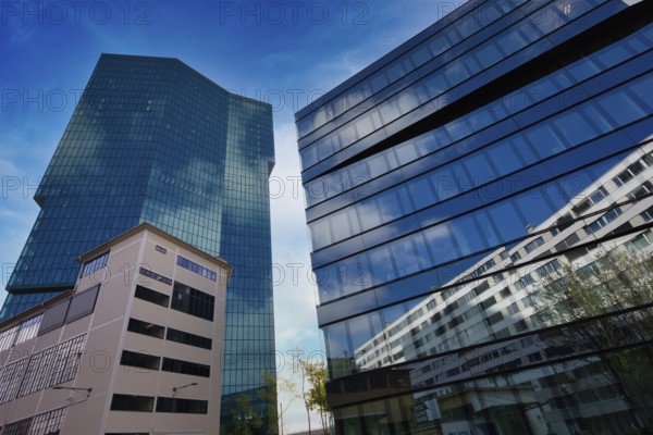 High-rise buildings with glass facades and sky in the background in urban style, Prime Tower,