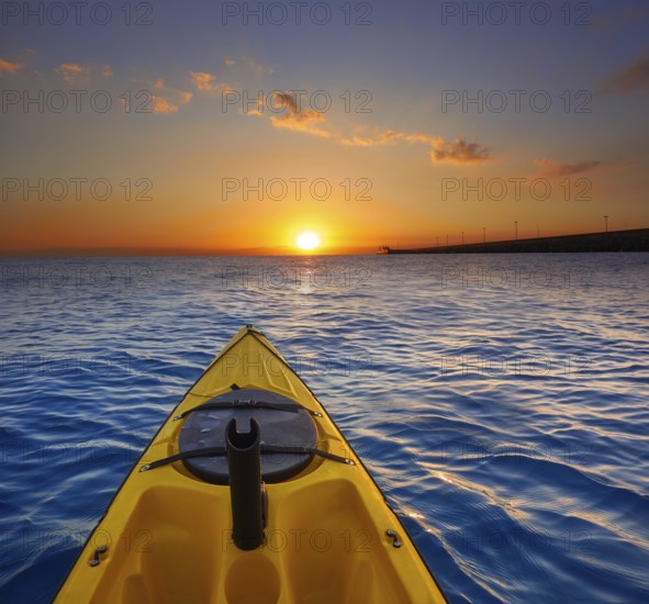 Kayak sailing in ocean sea at sunset or sunrise