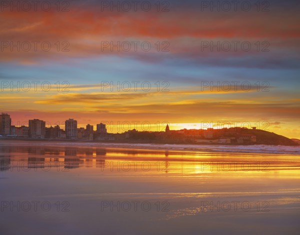 Gijon skyline sunset in San Lorenzo beach of Asturias in Spain