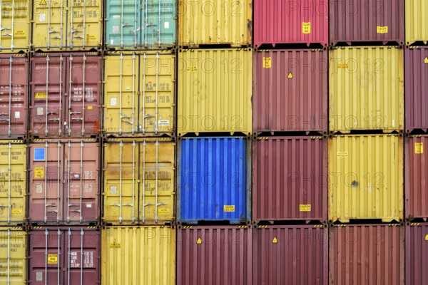Standard shipping container in a container terminal in front of loading onto a container ship