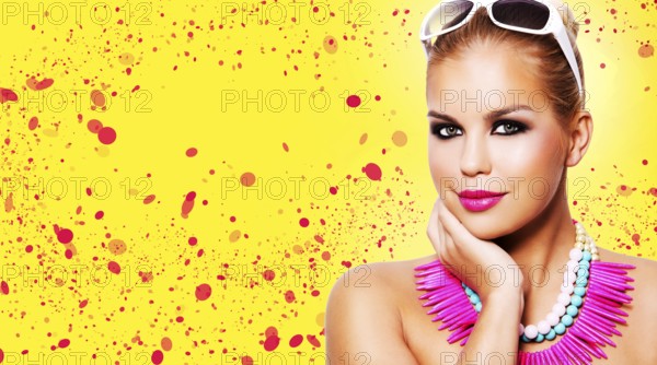 Beautiful woman with dark makeup and pink lipstick posing on yellow background wearing bright