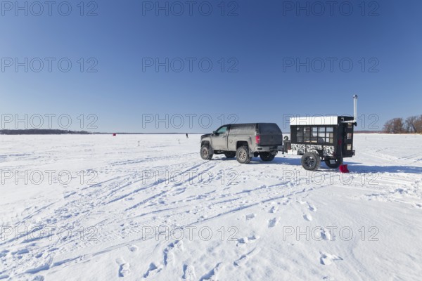 Winter, car with a heated trailer on the frozen Saint Lawrence River, Province of Quebec, Canada,