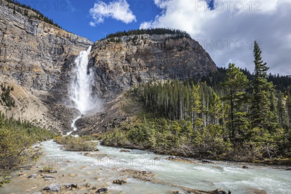 Rocky Mountains of Canada. Autumn Takakkaw Falls forms a full-flowing water flow of pearl color.