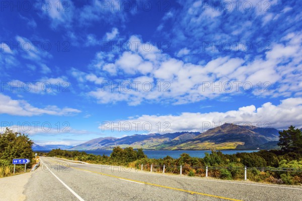 South Island. The beautiful lake Wanaka in New Zealand. Cirrus clouds fly in the sky. Azure lake
