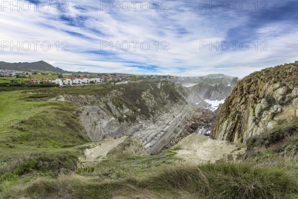Cantabria Beaches, Portio Beach. Windy stormy day on the Atlantic coast. Giant rough gray rocks and