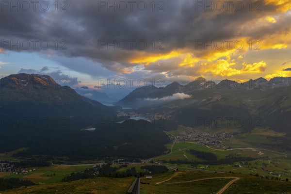 Beautiful Aerial View over Five Lakes and Swiss Alps and Cityscape in Sunset and Storm Clouds over