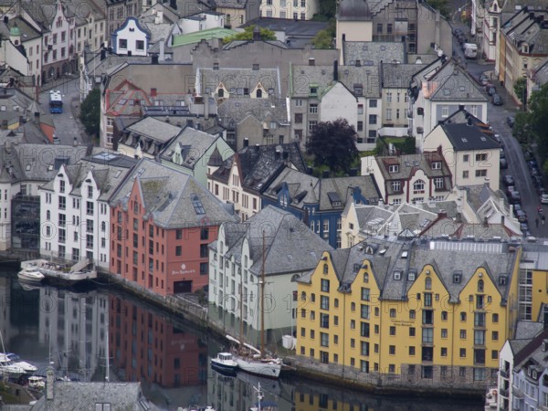 Colourful buildings on the harbour are reflected in the water. Historic architecture and
