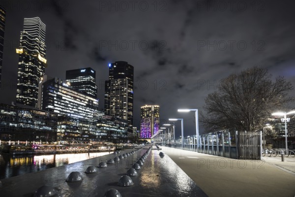 MELBOURNE, AUSTRALIA - JULY 5, 2024: Melbourne skyline as seen at dusk from Sandridge Bridge near