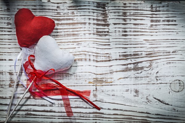 Valentine hearts with ribbons on wooden board holidays concept