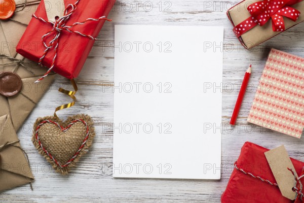 White paper and retro mail envelopes on wooden table. Flat lay cute composition with handmade