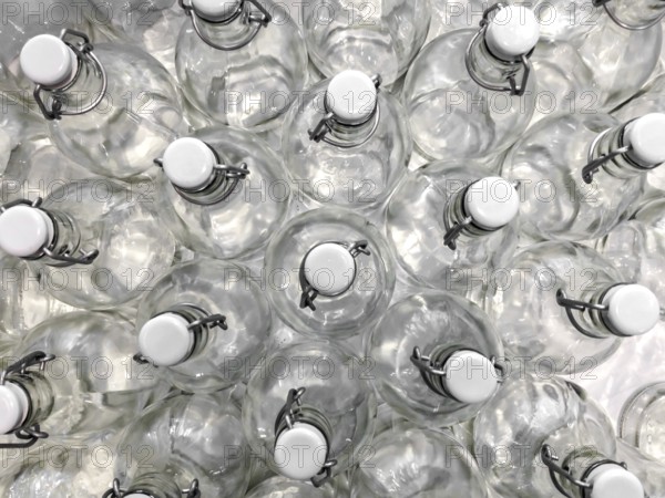 Transparent bottles seen from above. They can be filled with water, wine or other beverage. They