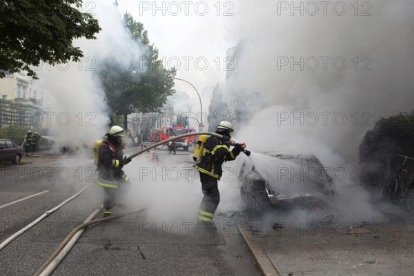 Fire brigade extinguishes burning cars on the Elbchaussee in Hamburg after the riots at the G20