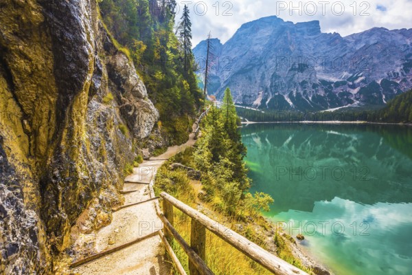 The concept of environmental and hiking. Walking trail around the lake is fenced with wooden