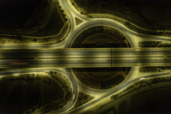 Aerial drone top view of motorway junction. Roundabout with cars moving. Transportation