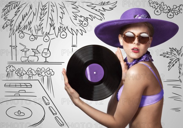 Colourful photo of a beautiful DJane in a bikini holding a retro vinyl record in her hands on a