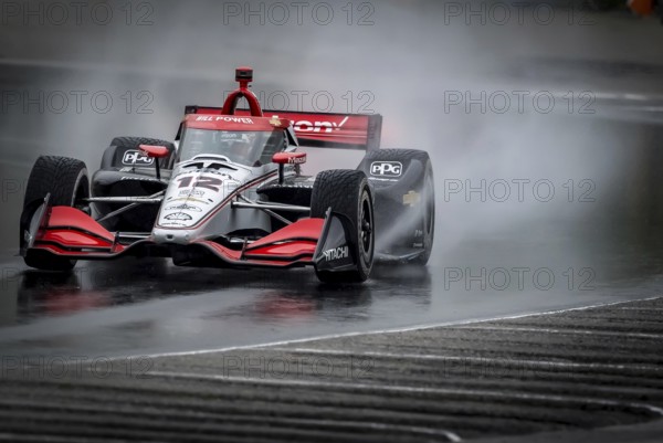 WILL POWER (12) of Toowoomba, Australia comes through turn 12 (Canada Corner) during a wet practice