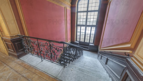 Elegant interior with curved staircase, red walls and large window, Villa Woodstock, Lost Place,