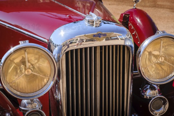 Lisbon, Portugal - Sep 29, 2024: Close view of front grille, headlights and hood of vintage red