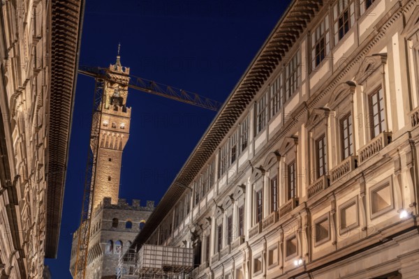 The famous Uffizi and the tower of the Palazzo Vecchio of Florence illuminated at night, Italy,