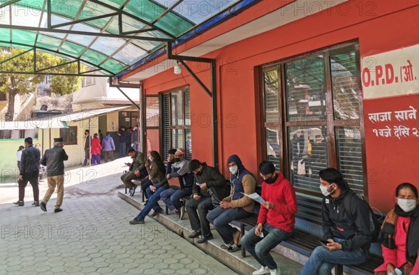 Kathmandu, Nepal, 16 March 2020: People wearing protecting masks outside a hospital, waiting for