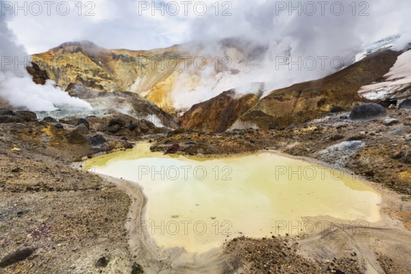 Lake in crater of active volcano. Beautiful dramatic volcanic landscape: hot spring, fumarole,