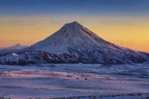Stunning winter mountain landscape of Kamchatka Peninsula, beautiful morning snow capped cone of