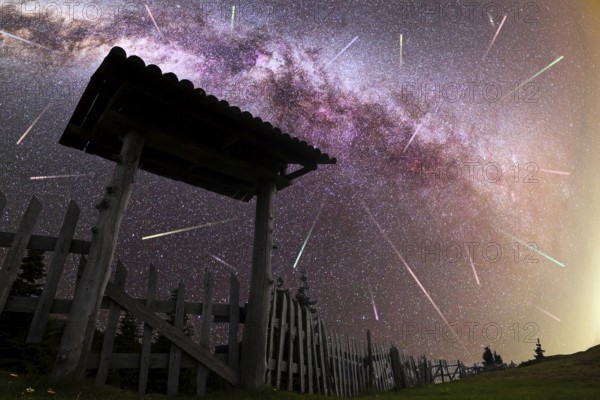 A view of a Meteor Shower and the purple Milky Way with wooden entrance door with a roof and fence