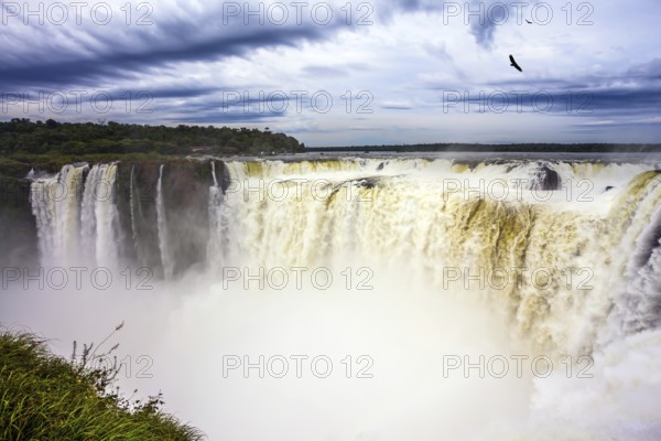 Grandiose waterfalls Iguazu in the rainy season - the Devil's Throat. Over the rumbling waterfall