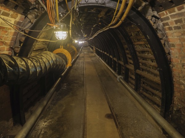 Dark industrial tunnel with brick walls and visible lighting, Bochum, North Rhine-Westphalia,