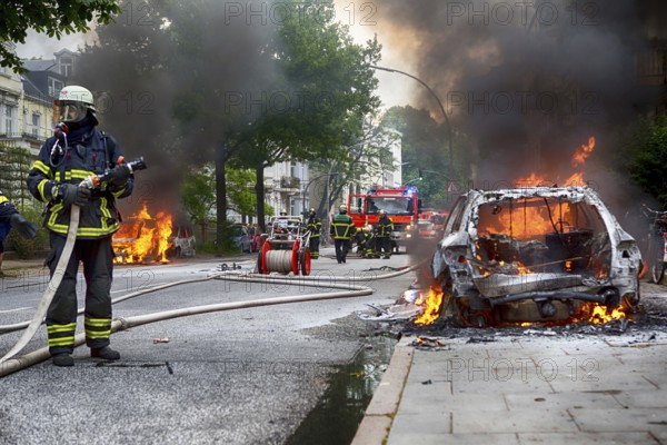 Fire brigade extinguishes burning cars on the Elbchaussee in Hamburg after the riots at the G20