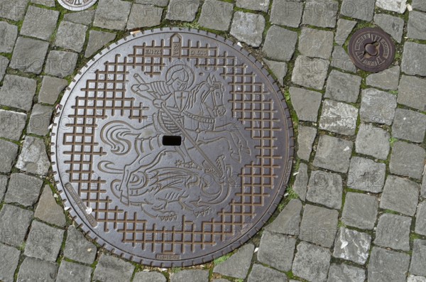Manhole cover with coat of arms of the municipality of Stein am Rhein, dragon slayer, Canton