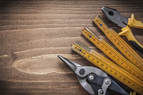 Set of steel cutter pliers wooden meter construction concept