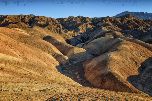 Zabriskie Point, sunrise, sun, golden path raod composed of sediments from Furnace Creek Lake,