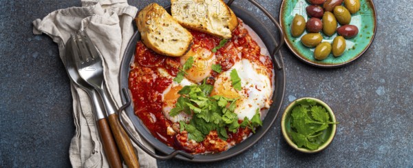 Middle Eastern and Maghrebi healthy dish Shakshouka made of eggs and tomato sauce served in pan