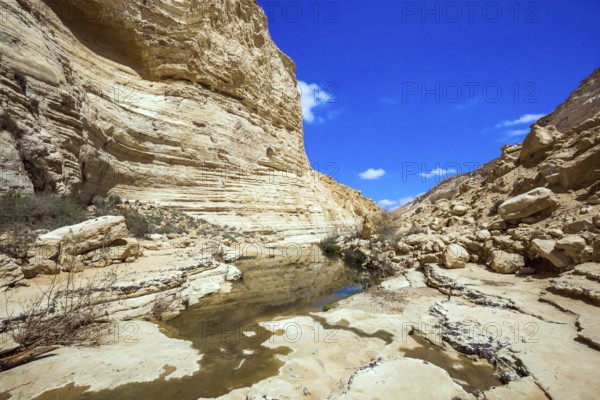 Start route. The walls of the gorge are corroded by caves. Israel. The ravine is formed by the