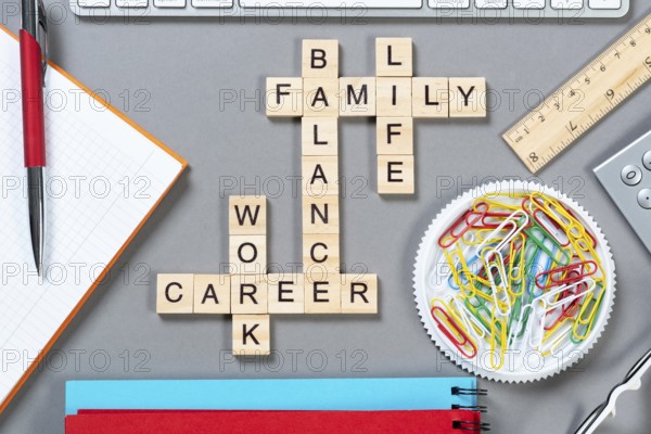 Business motivation concept with words from cubes. Still life of office workplace with crossword.