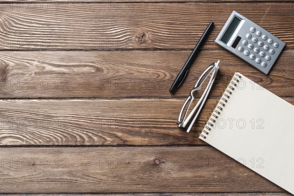 Still life of accountant vintage workspace with office accessories. Flat lay old hardwood desk with