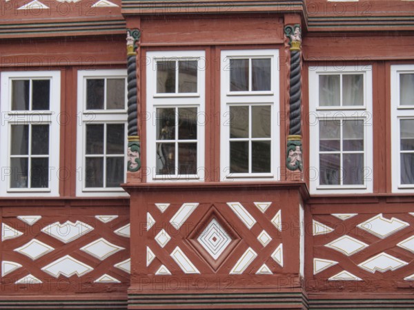 Half-timbered façade with red struts, spiral columns and decorative geometric patterns, Mainz,