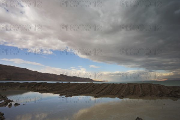 Sunset. Incredible lighting effects on the Dead Sea in Israel. Picturesque sediment mixture of sea